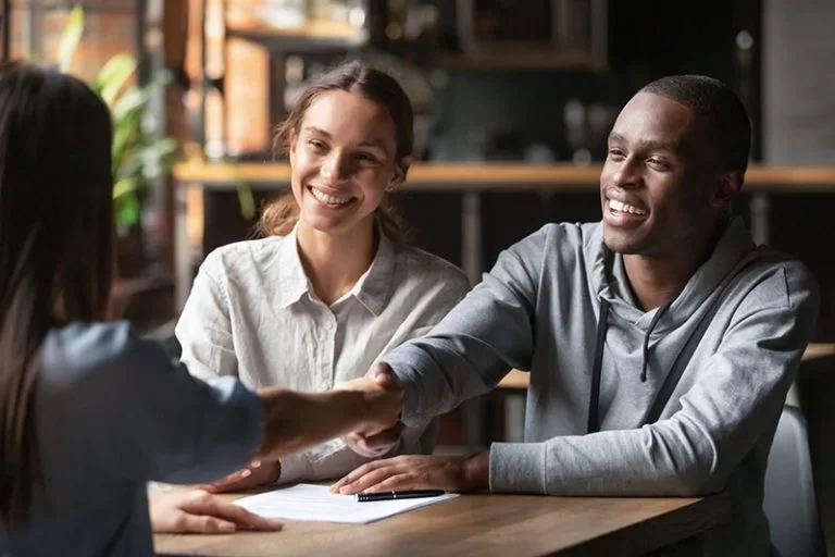 Couple-shaking-hands-with-loan-officer