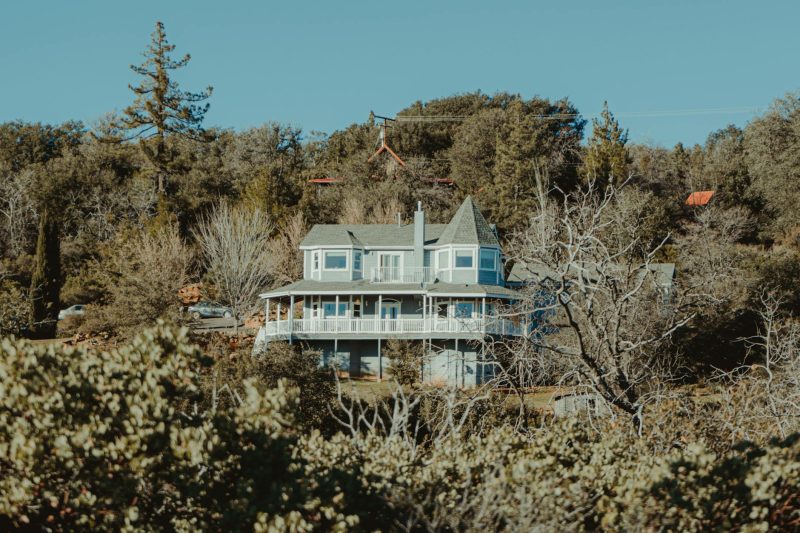 Picturesque house surrounded by trees and greenery in Julian, California, highlighting its architectural beauty.